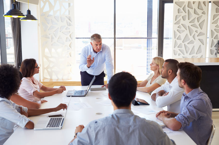 41393376 - mature businessman presenting to colleagues at a meeting